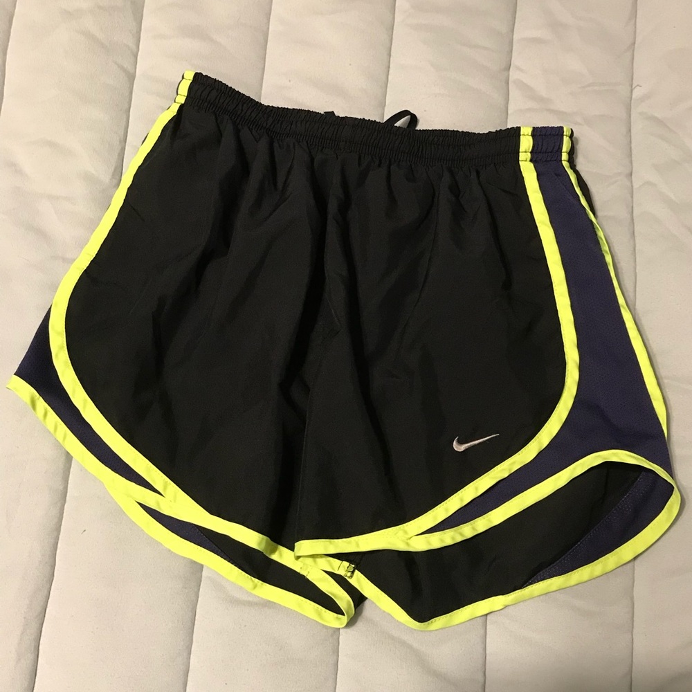 Small black Nike running shorts with highlighter yellow and dark purple.